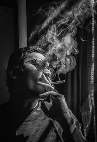 Portrait of young man smoking cigarette