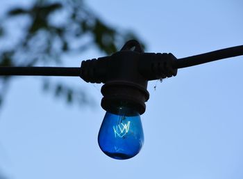 Low angle view of light bulb against clear sky