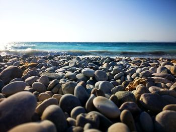 Stones on beach against clear sky