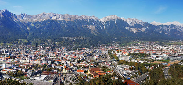 High angle view of townscape and mountains against sky