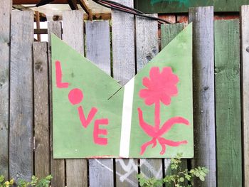 Close-up of text on wooden fence