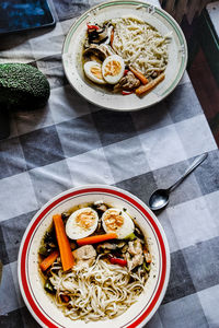 High angle view of food in bowls on tablecloth