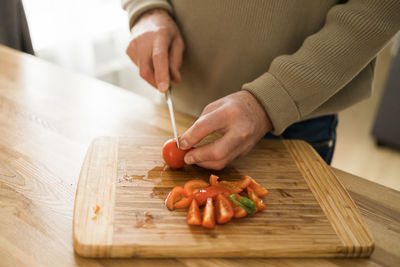 Midsection of man preparing food on table