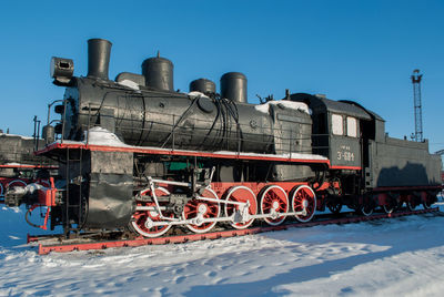 Graffiti on train against clear sky during winter