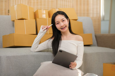 Portrait of young woman using mobile phone