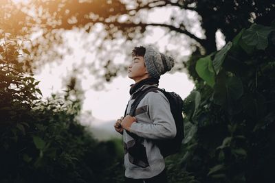 Close-up of young man standing in forest