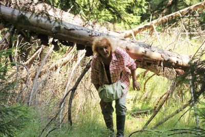 Portrait of man standing in forest