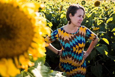 Full length of woman standing on sunflower