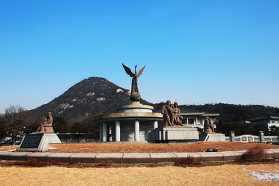 Sculpture of building against clear blue sky