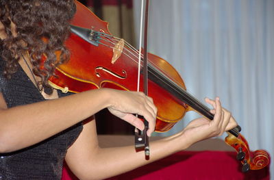 Low section of woman playing guitar