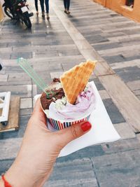 Cropped image of woman holding ice cream
