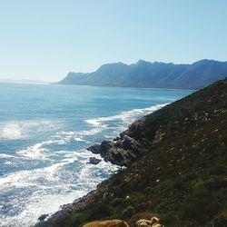 Scenic view of sea with mountains in background