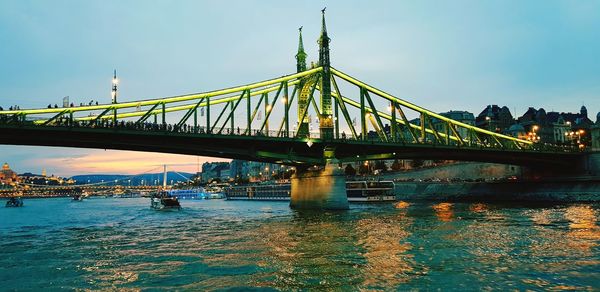 Bridge over river with city in background