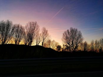 Silhouette bare trees against sky during sunset