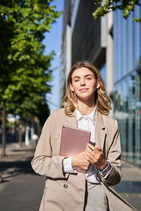 Portrait of young woman using mobile phone