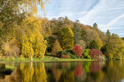 View of the autumn colours around the lake at stourhead gardens in wiltshire.