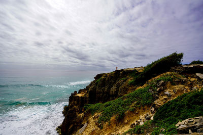 Scenic view of rocky mountain and sea against sky