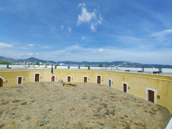 Built structure on beach against sky