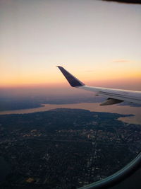 Aerial view of city against sky during sunset