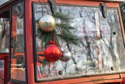 Close-up of christmas decoration hanging on bus