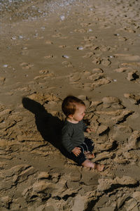 High angle view of woman sitting at beach