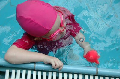 Midsection of girl swimming in pool
