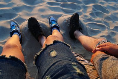 Low section of people standing on beach