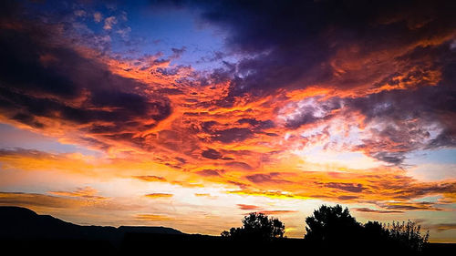 Low angle view of dramatic sky during sunset