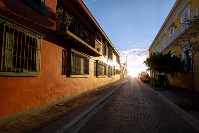 Narrow street amidst buildings against sky