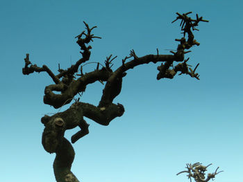 Low angle view of statue against clear blue sky