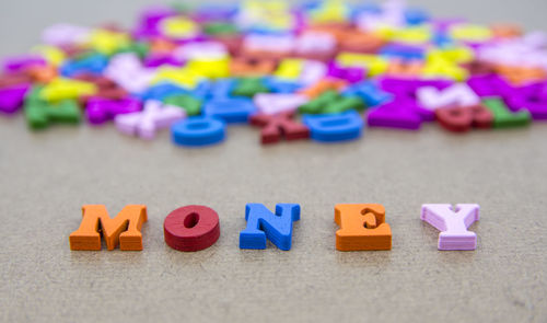 Close-up of colorful money text on table