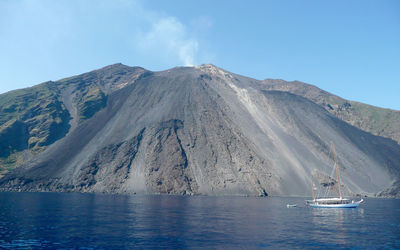 Scenic view of sea and mountains against sky