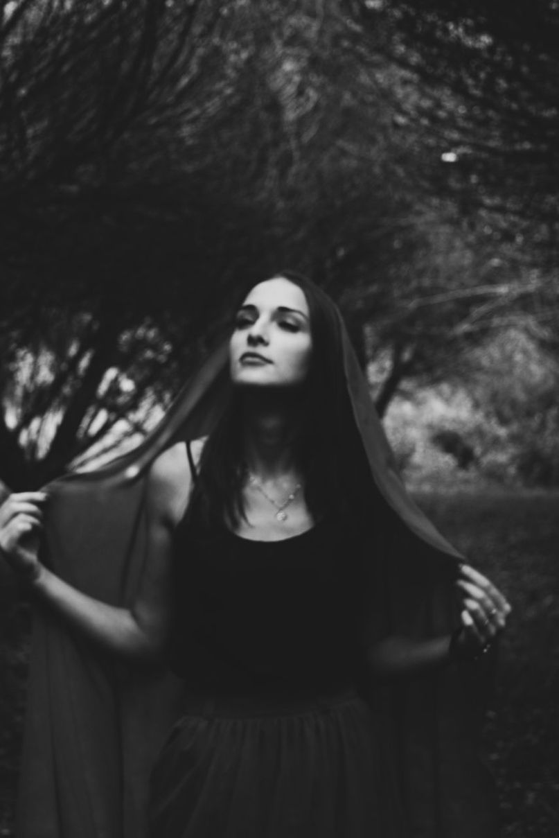 front view, one person, three quarter length, tree, lifestyles, real people, leisure activity, women, young adult, standing, casual clothing, adult, young women, day, portrait, hairstyle, fashion, plant, beautiful woman, contemplation