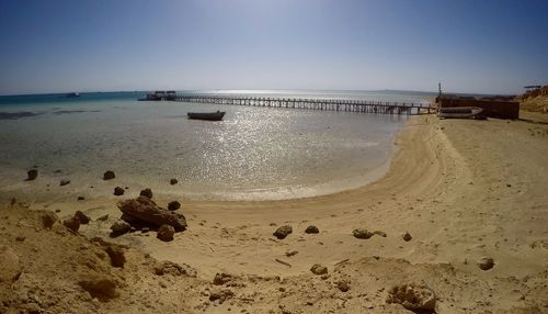 Scenic view of beach against clear sky