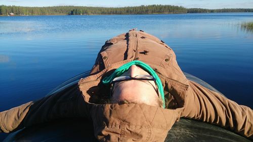 Woman lying on boat at lake