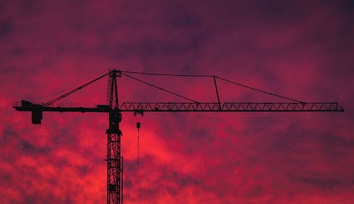 Silhouette of a crane against a red sunset sky in amsterdam the netherlands