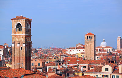 Many bell towers and more roofs in venice in italy