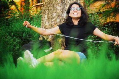 Portrait of smiling young woman in park