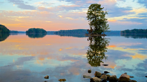 Scenic view of lake against sky at sunset