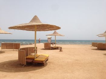 Lifeguard hut on beach against clear sky