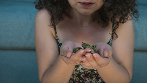 Midsection of woman holding marijuana