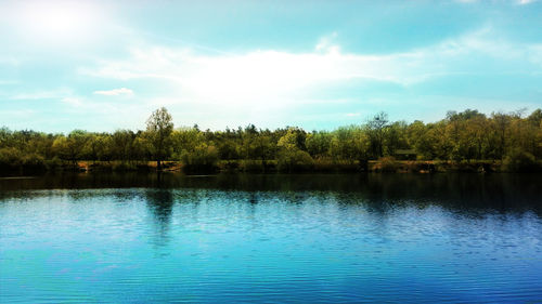 Scenic view of lake against cloudy sky