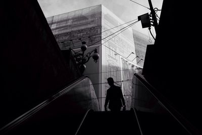 Low angle view of silhouette person on escalator