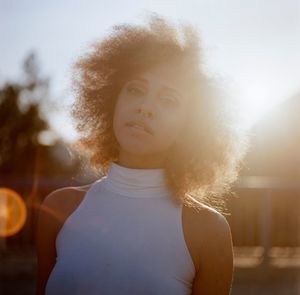 Close-up of woman standing against white background