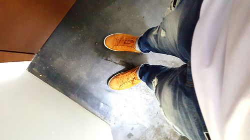 Low section of woman standing on tiled floor