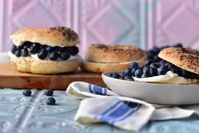 Cream cheese and whole fresh blueberries on sliced bagels