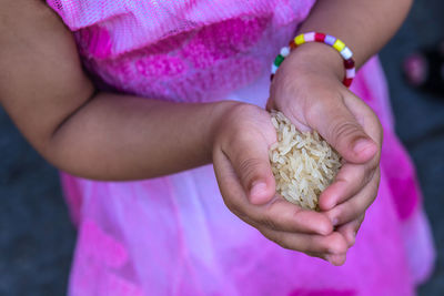 Close-up of girl holding rice