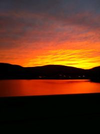 Scenic view of sea against orange sky