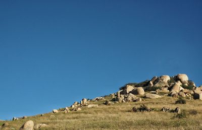 Scenic view of mountains against blue sky