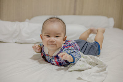 Cute boy lying on bed at home